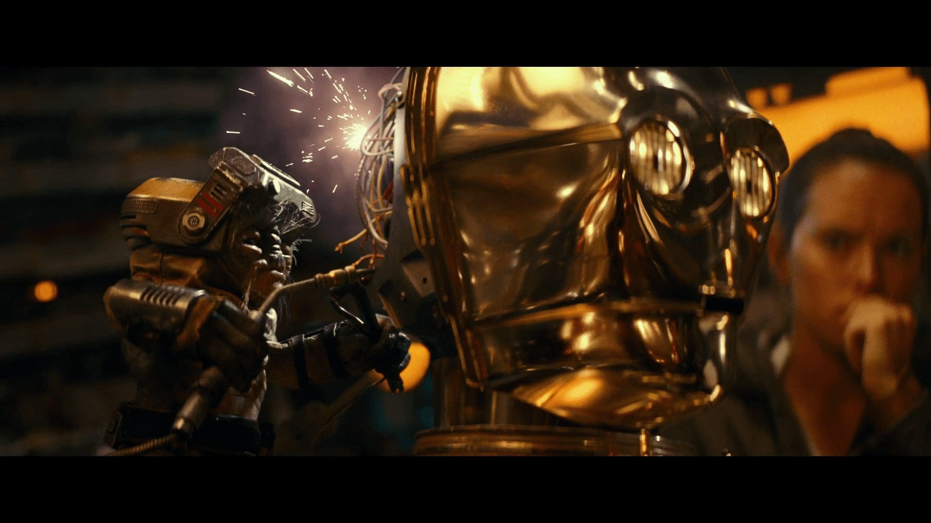 Babu Frik working on C-3PO as the heroes look on