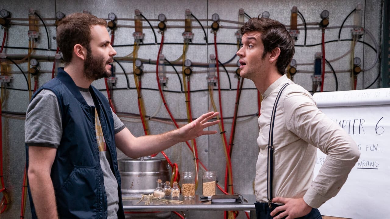 Wilhelm and Adam in their taproom at Rodman’s Brewery, surrounded by tanks and glasses of beer.
