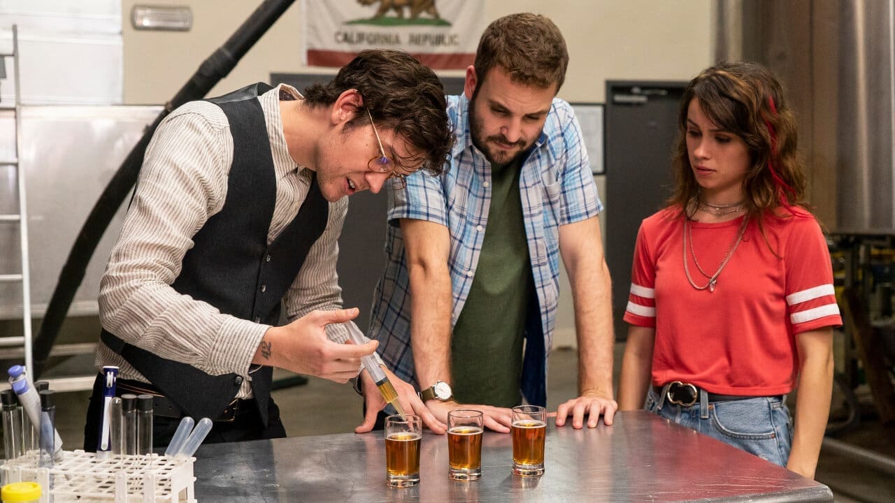 The Rodman’s crew in the brewhouse with stainless tanks and hoses in the background.