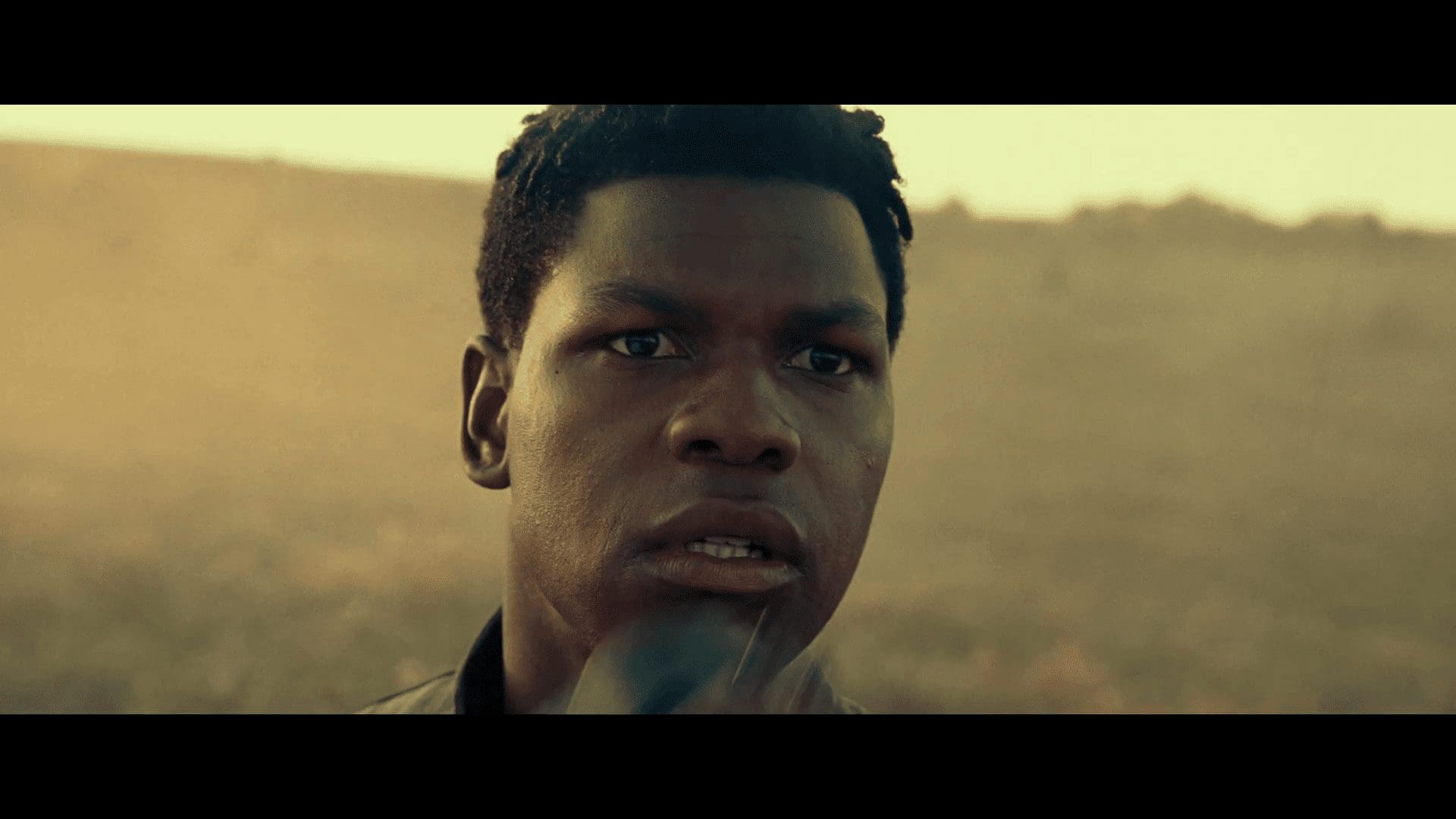 Finn looking through macrobinoculars on a desert world